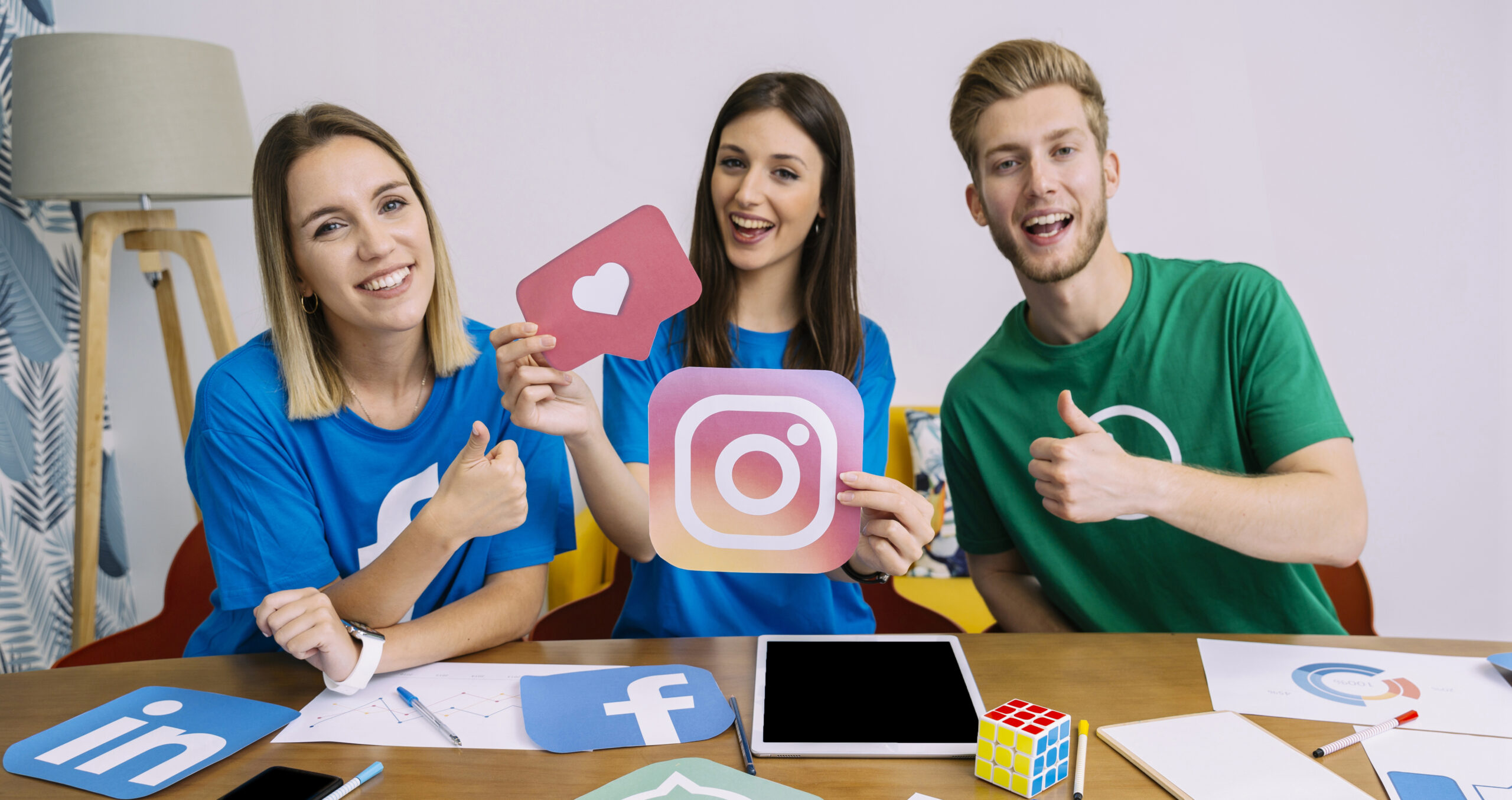 woman-holding-snapchat-logo-with-his-friends-showing-thumbup-sign